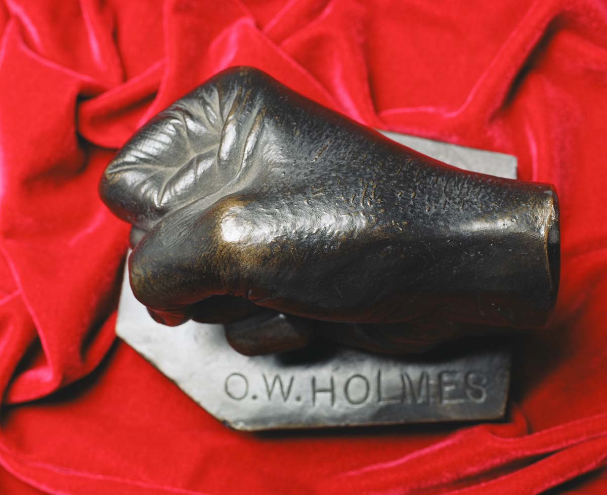 Bronze fist sculpture with engraved text "O.W. Holmes" 