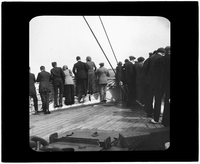 Passengers line the ship railing