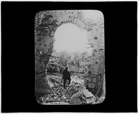 Soldier posing in a hole in a wall