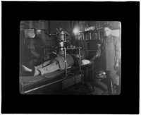 Patient being x-rayed by three technicians